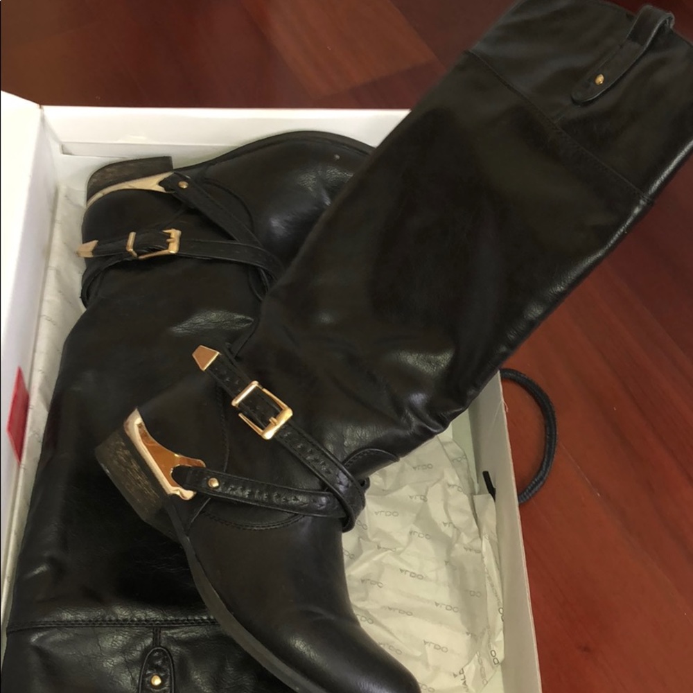 Women’s black and gold boots to the knee